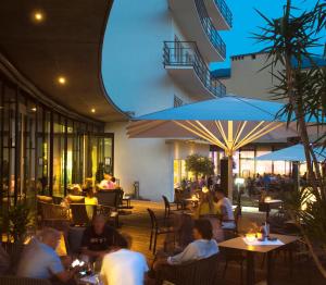 a group of people sitting at tables in a restaurant at Parkhotel Hall in Tirol in Hall in Tirol +92 photos