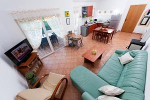 Una sala de estar con un sofá azul y una cocina. en Villa Istria, en Poreč