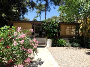 una casa con flores rosas delante de ella en Campsite Sunny Home Soline en Biograd na Moru