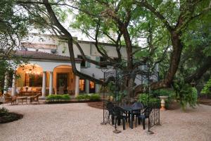 a table and chairs in front of a house at Angel Oak guesthouse in Brits