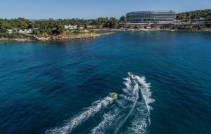 a boat in the middle of the water at Four Seasons Astir Palace Hotel Athens in Athens