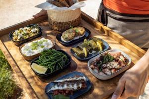 a tray of different types of food on a table at Four Seasons Astir Palace Hotel Athens in Athens