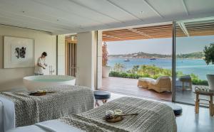 a living room with a view of the ocean at Four Seasons Astir Palace Hotel Athens in Athens