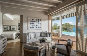 a living room with a couch and a table at Four Seasons Astir Palace Hotel Athens in Athens
