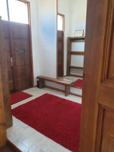 a room with a door and a red rug at Bartas apartment in Liepāja