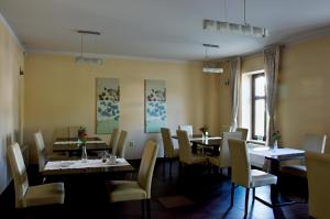 a dining room with tables and chairs and a window at Penzion Haydnuv Dum in Dolní Lukavice