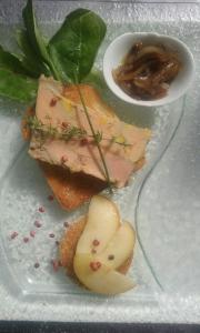 a plate with a sandwich with meat and a sauce at Hotel - Restaurant de la Paix in Barbotan-les-Thermes