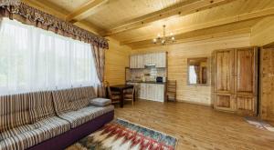 a living room with a couch and a kitchen at Апартаменты Solnce Karpat in Polyana