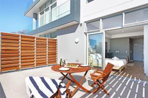 a patio with a table and chairs and a bedroom at Trendy, Central Sentinel - Heart of Cape Town in Cape Town