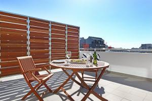 a table and two chairs on a balcony at Trendy, Central Sentinel - Heart of Cape Town in Cape Town +4 photos