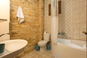 a bathroom with a toilet and a tub and a sink at Izabella Sea Side Villa in Siviri +41 photos