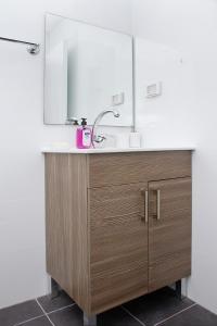 a bathroom with a sink and a mirror at Apartments4you Maya in Bat Yam