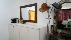 a mirror on a white cabinet with a hat on it at MYHome@Langkawi in Pantai Cenang +23 photos