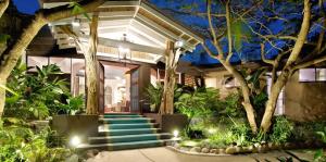 a house with stairs and trees in front of it at Villa Don Vito in Tamarindo