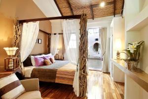 a bedroom with a canopy bed with curtains at Villa Don Vito in Tamarindo +36 photos