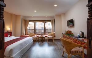 A bed or beds in a room at Hotel Manaslu