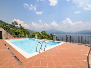 a swimming pool with a view of the water at Belvilla by OYO Panoramica in Oggebbio