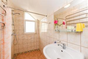a bathroom with a sink and a shower at Vila Krantas in Palanga +41 photos