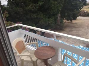 Una mesa y sillas en un balcón con una mesa. en Jack's Apartments, en Kefalos