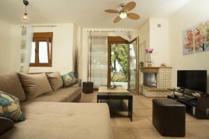 a living room with a couch and a fireplace at Izabella Sea Side Villa in Siviri