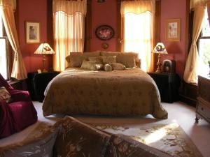 a bedroom with a large bed and two windows at Riverview Mansion Hotel in Golconda