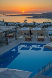 a swimming pool with a sunset in the background at Sunset View Hotel in Parikia
