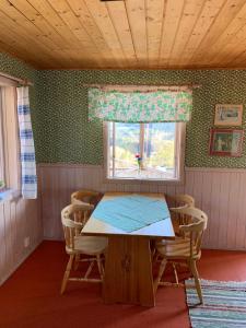 Utsiktens turistgård في Järkvitsle: طاولة وكراسي في غرفة مع نافذة
