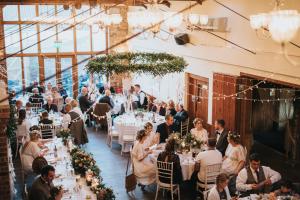 a wedding reception in a building with people sitting at tables at Hall Farm Hotel And Restaurant in Ashby cum Fenby