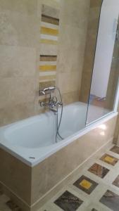 a bath tub with a faucet in a bathroom at LA VILLA DEL CONTE in Barletta +38 photos
