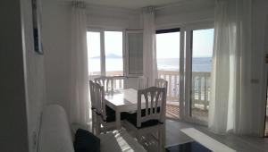 a dining room with a table with a view of the ocean at Torre Luquillo in La Manga del Mar Menor