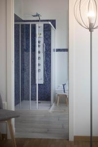 a bathroom with a shower with a glass door at La Casa di Amedeo in Piombino Dese