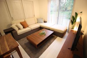 a living room with a couch and a coffee table at HOPE VILLA ONNASON in Onna