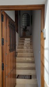 a hallway with a staircase with wooden doors at Casa Miguel in Montejaque