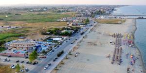 an aerial view of a beach with cars parked at Hotel Aperio in Paralia Katerinis