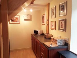 a kitchen with a counter with a microwave on it at THE RETREAT in Hereford