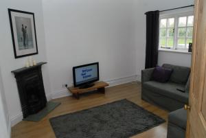 A television and/or entertainment centre at Greysfield Cottage