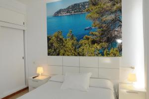 a white bedroom with a view of the ocean at Mini Golf Apartments in Canyamel