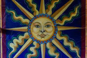 a painting of the face of the sun on a wall at Agriturismo Mezzaluna in Málchina