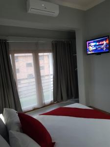 1 dormitorio con 1 cama y TV de pantalla plana en ARCHITECT'S VIEW, en Durban