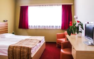 Ένα ή περισσότερα κρεβάτια σε δωμάτιο στο Hotel Veter