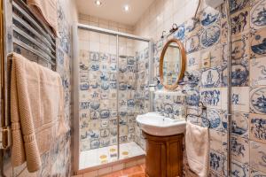 a blue and white bathroom with a sink and a shower at Angel House Vilnius, Pilies in Vilnius