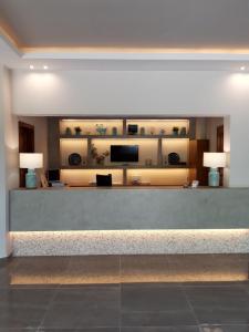 a lobby with a reception desk with two lamps at Asteris Village in Gerakini