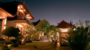 a house with lights on the side of it at The Kanha Palace in Nusa Penida