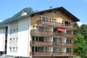 a building with wooden balconies on the side of it at Ferienwohnung Bündawiese in Davos +6 photos