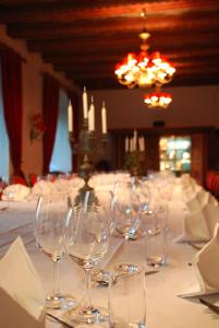 a long table with empty wine glasses on it at Häringe Slott in Västerhaninge