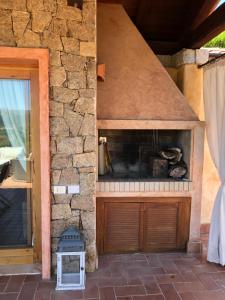 a stone wall with a fireplace in a building at Chia Villa Violet in Chia +36 photos