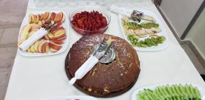a table with several plates of different types of food at The First Hotel Saranda in Sarandë