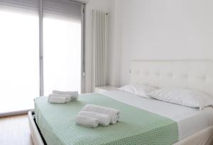 a bed room with a white bedspread and a white comforter at Housing32 Apartments in Milan