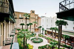 a view of a courtyard in a city with palm trees at Menger Hotel in San Antonio