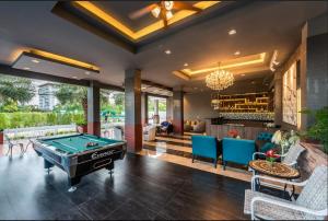 a living room with a pool table and a bar at Patra Luxury Hotel Suvarnabhumi in Ban Khlong Bang Krathiam